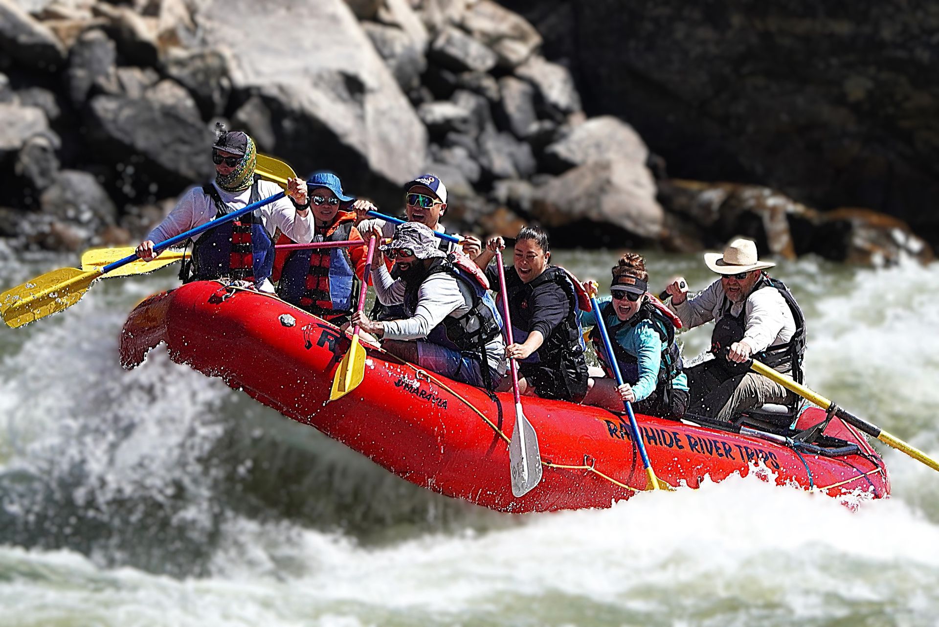 A whitewater raft navigating a scenic Idaho canyon on the Salmon River.