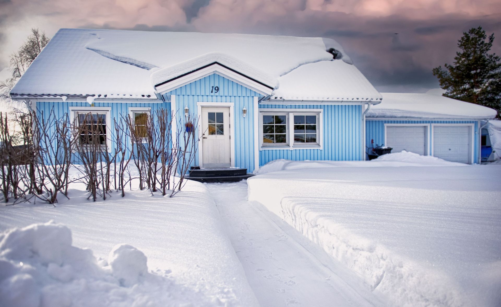Home covered in snow during a winter storm