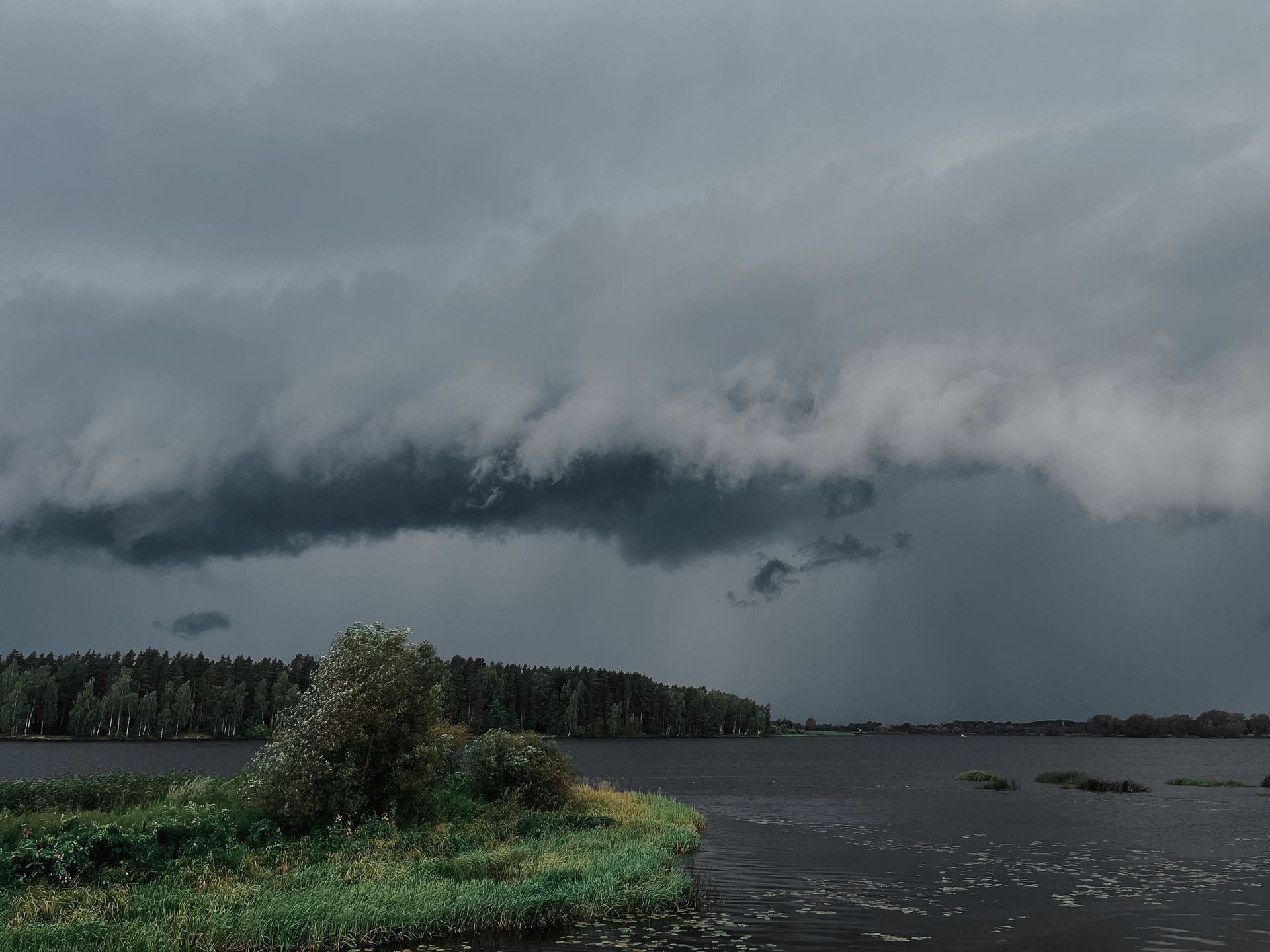 Dark storm clouds rolling over open land, the kind of severe weather that drives Oklahoma insurance rates