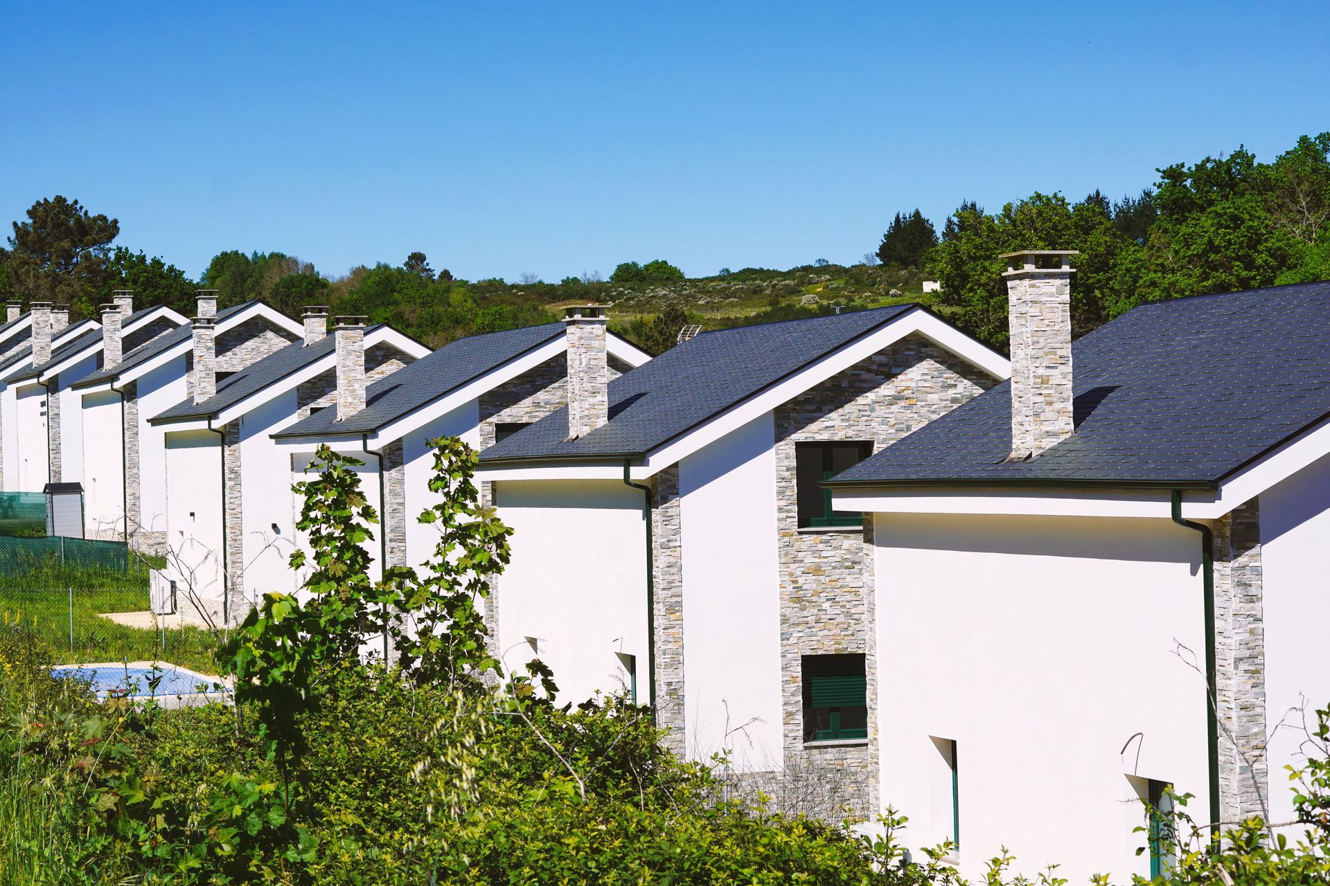 Row of similar homes with different roofs and different home insurance rates