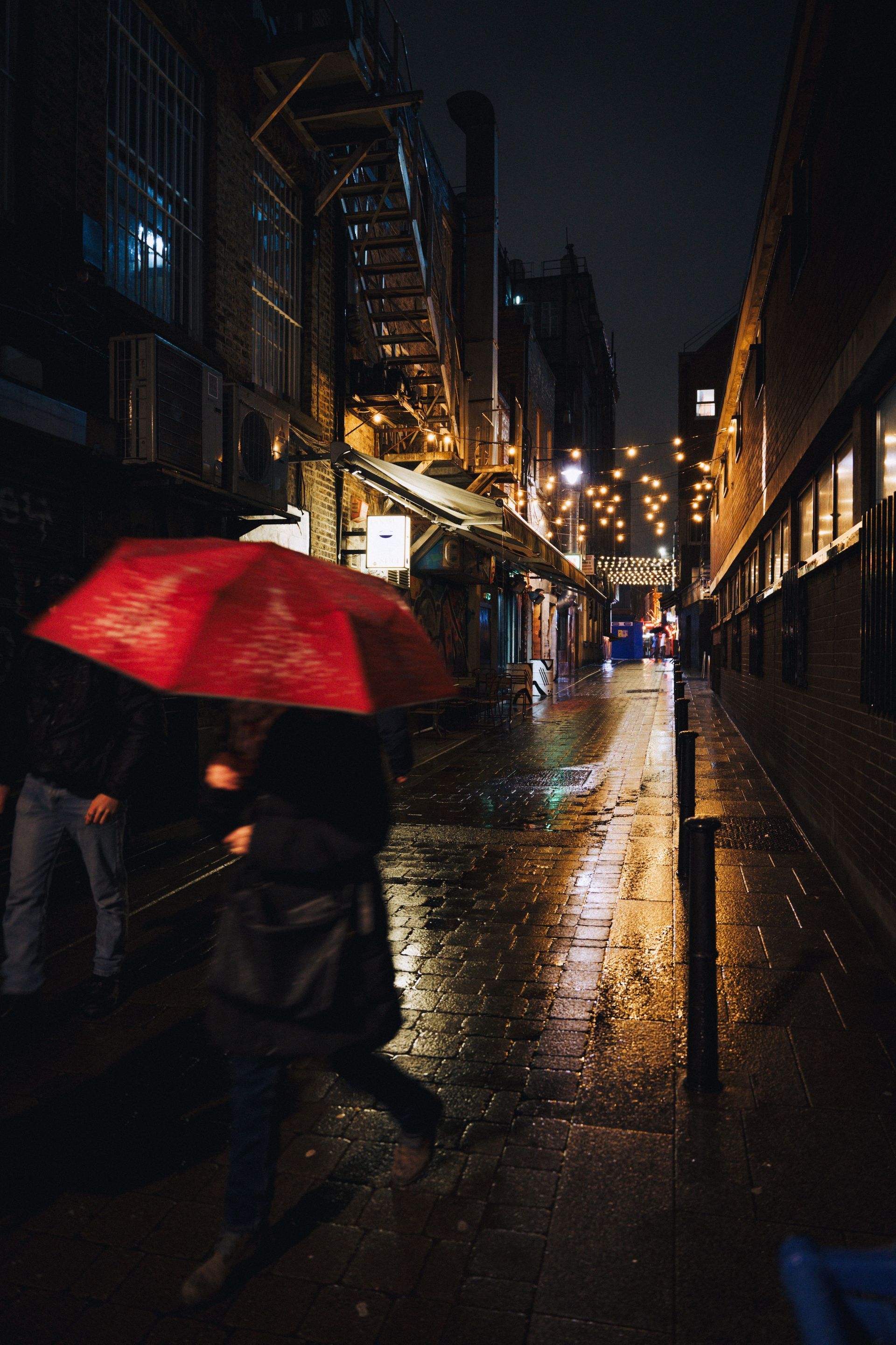 Red umbrella in the rain, a symbol of umbrella liability insurance