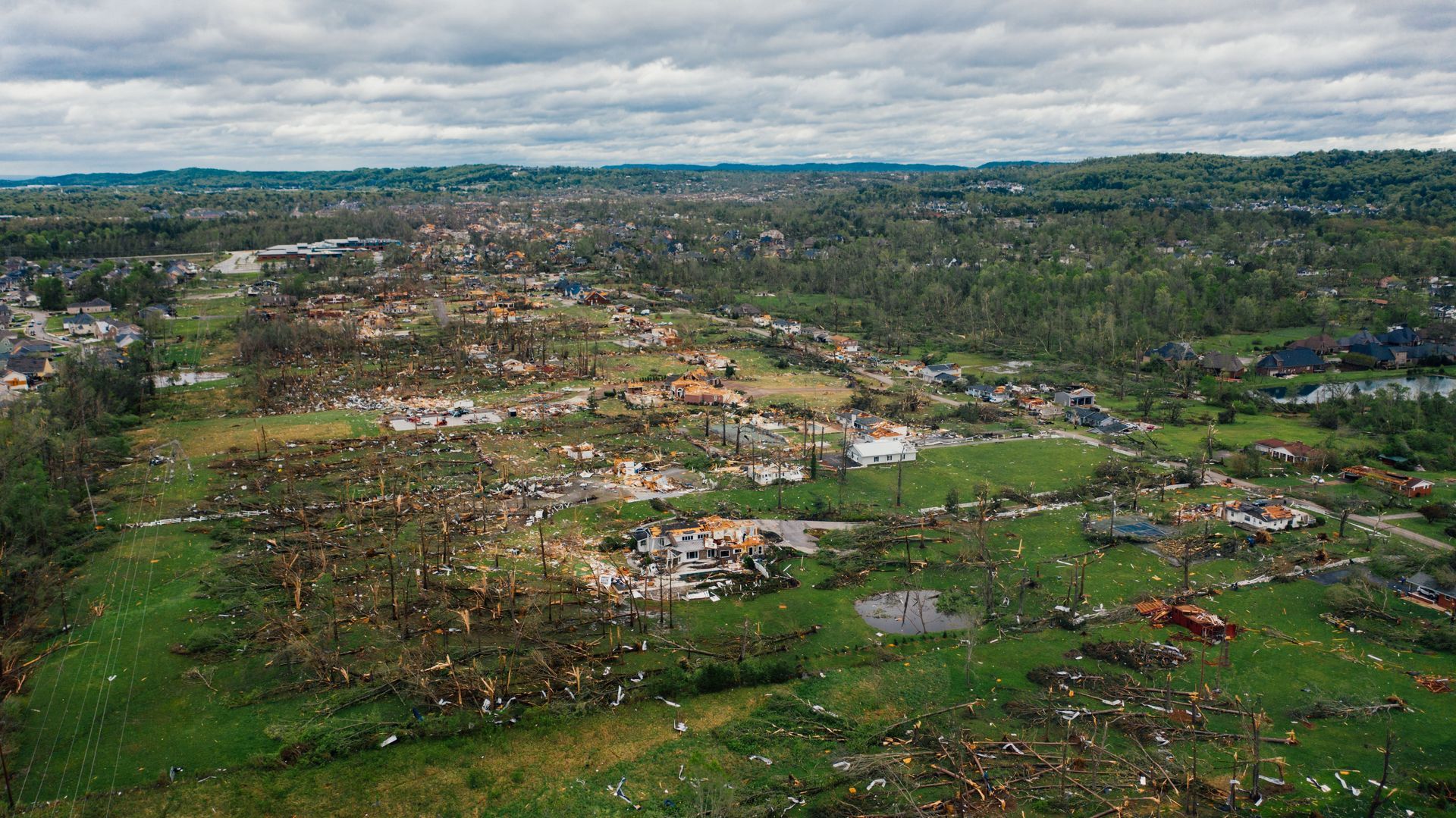 Aerial view of tornado damage to homes in a neighborhood