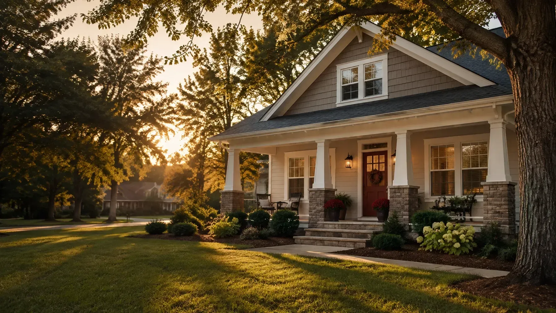Sunlit suburban house with front porch, stone facade, and landscaped lawn at dusk
