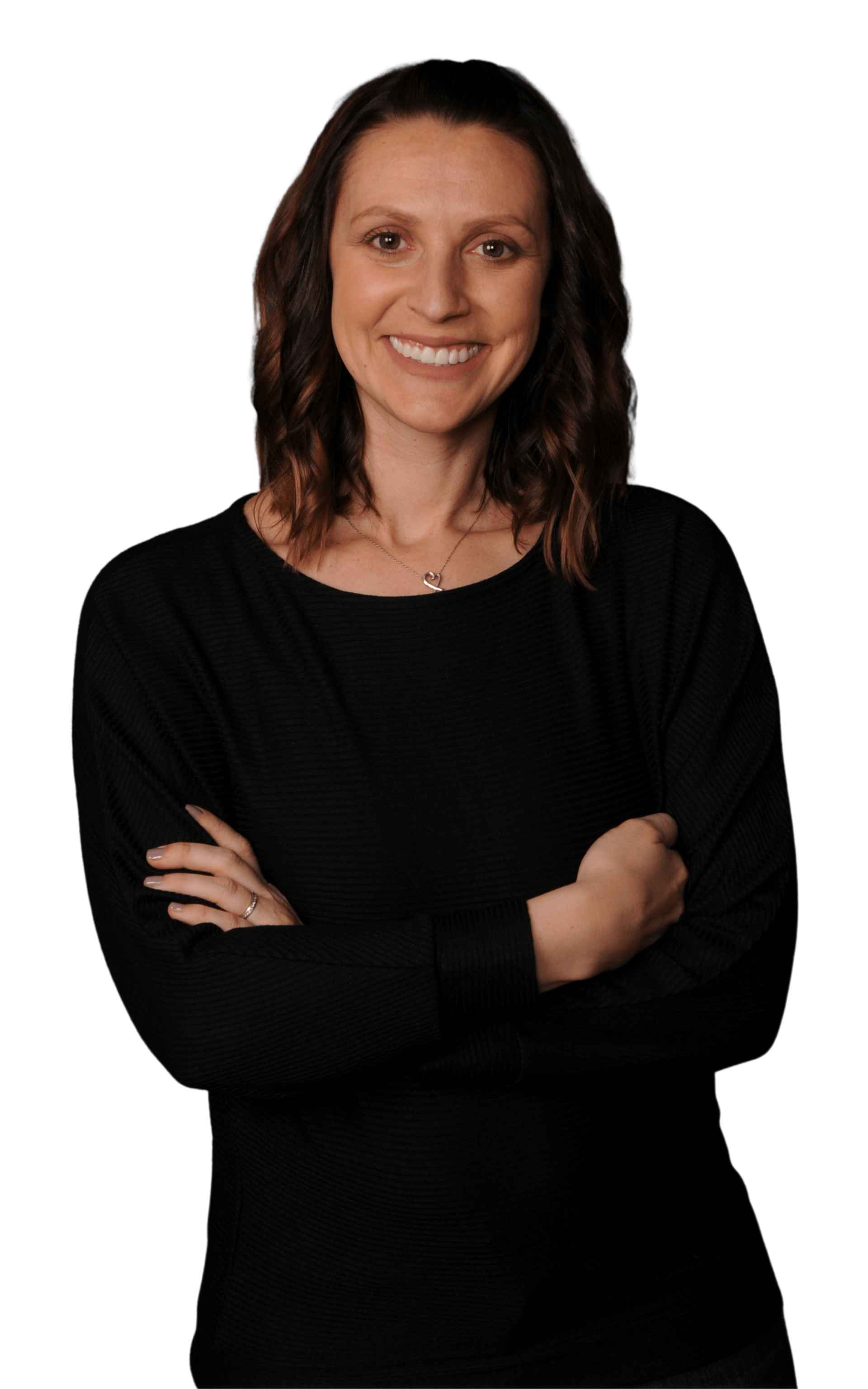 A woman in a black shirt is standing with her arms crossed and smiling.