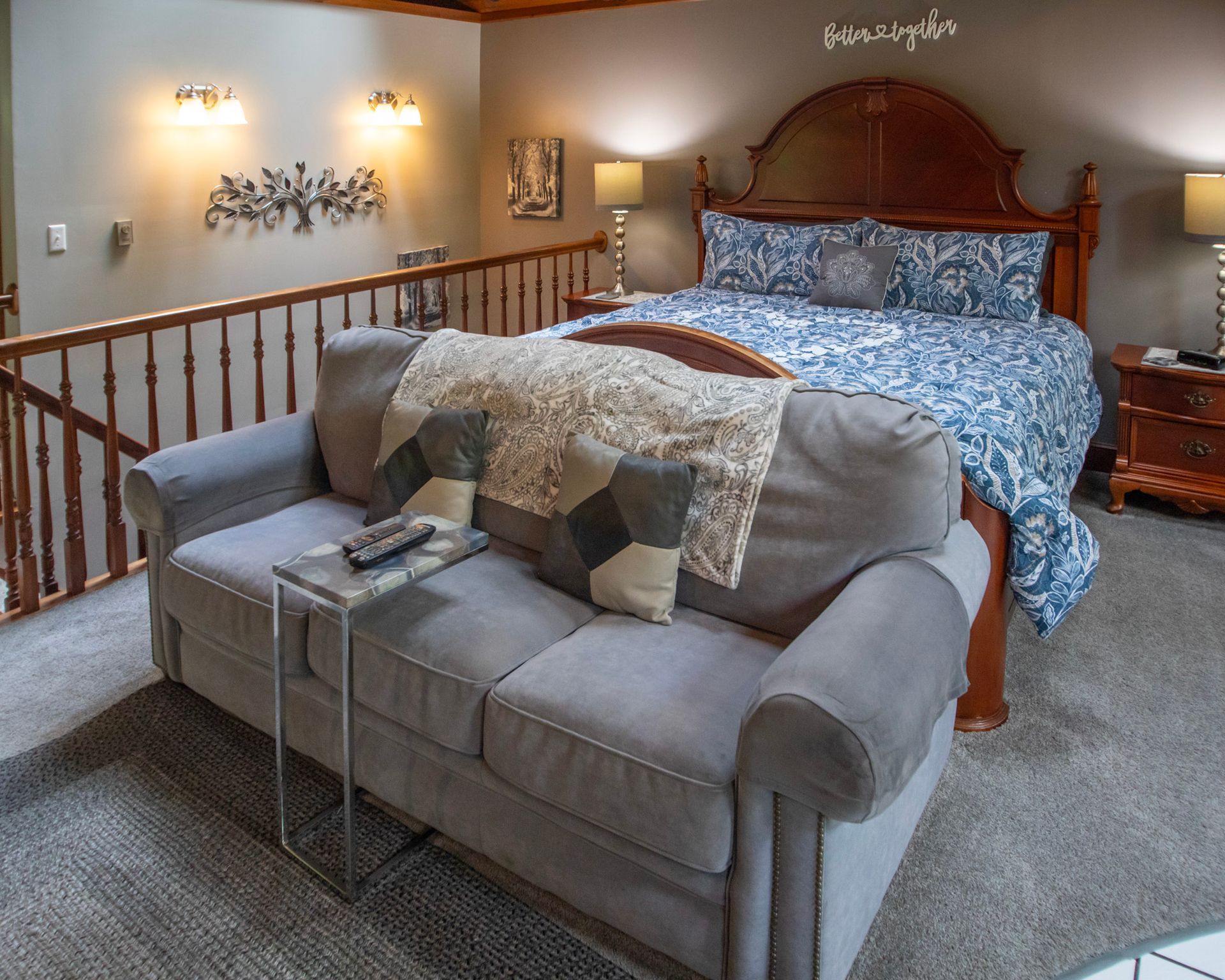 Cozy loft bedroom with sofa, bed, and decorative accents.