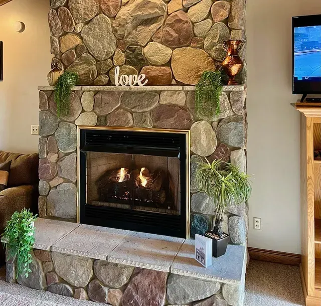 Stone fireplace with a burning fire,