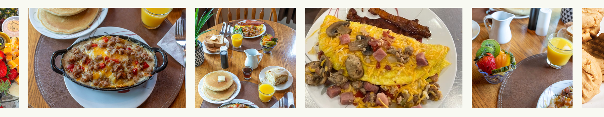 Breakfast dishes arranged on a table: omelet, pancakes, fruit, and orange juice.