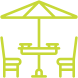 Table with umbrella and two chairs; outdoors.