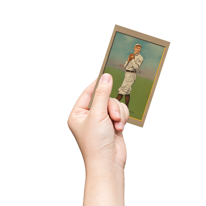 A hand holding up a baseball player on a trading card