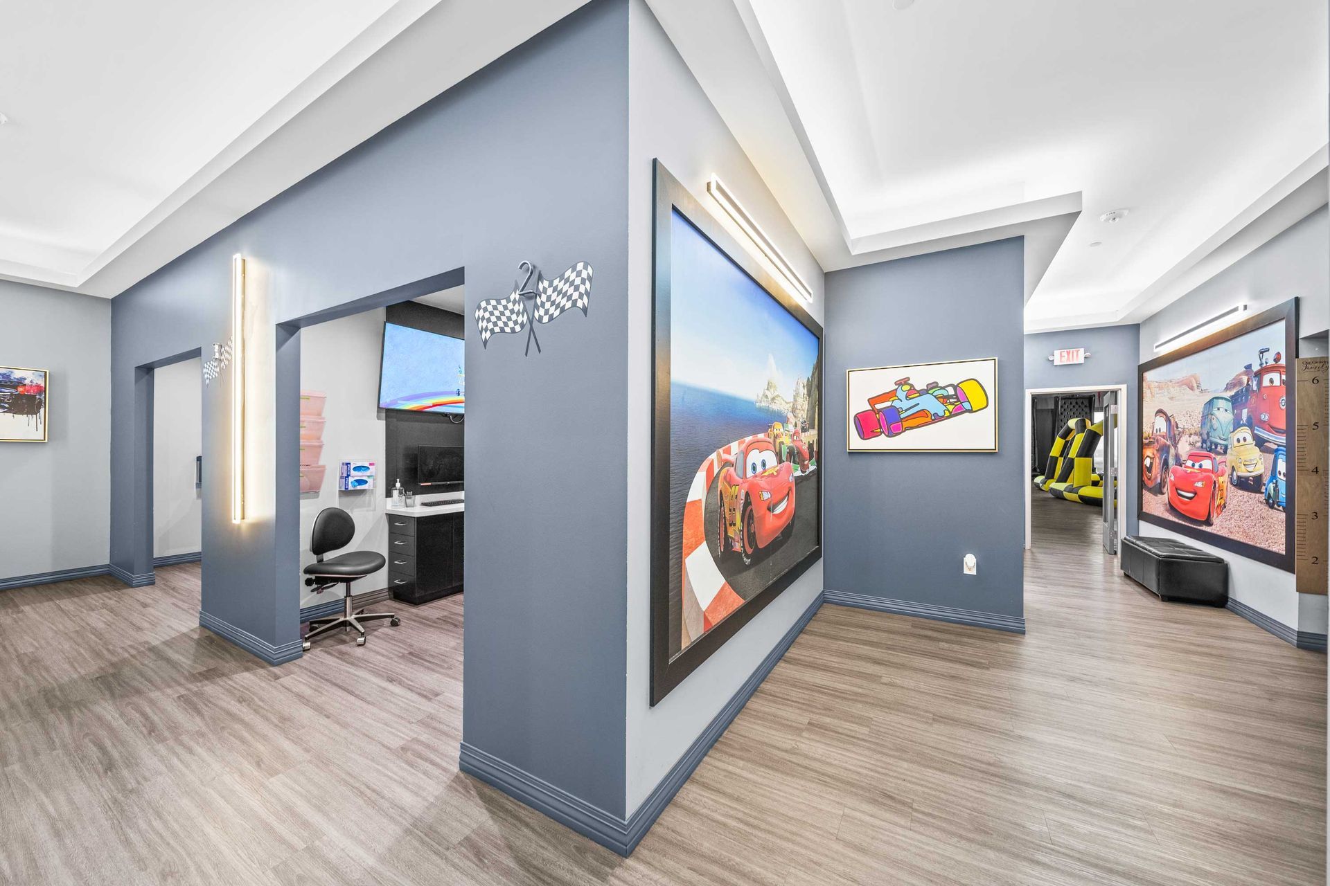Grand Prix Dental in Katy, TX A hallway with a lot of paintings on the wall.