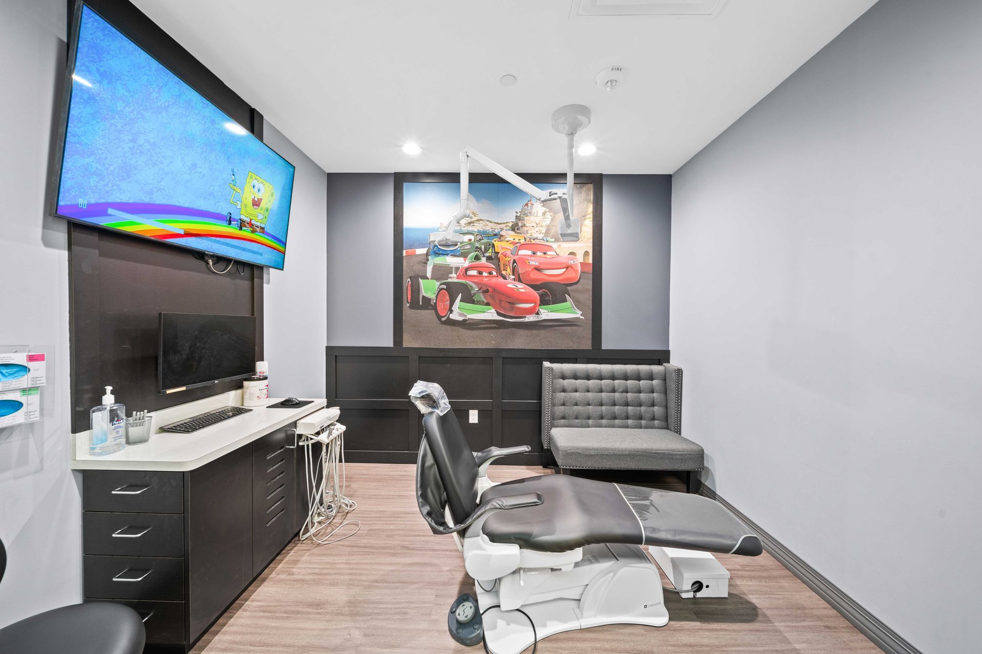 Grand Prix Dental in Katy, TX A dental office with a dental chair and a painting on the wall.