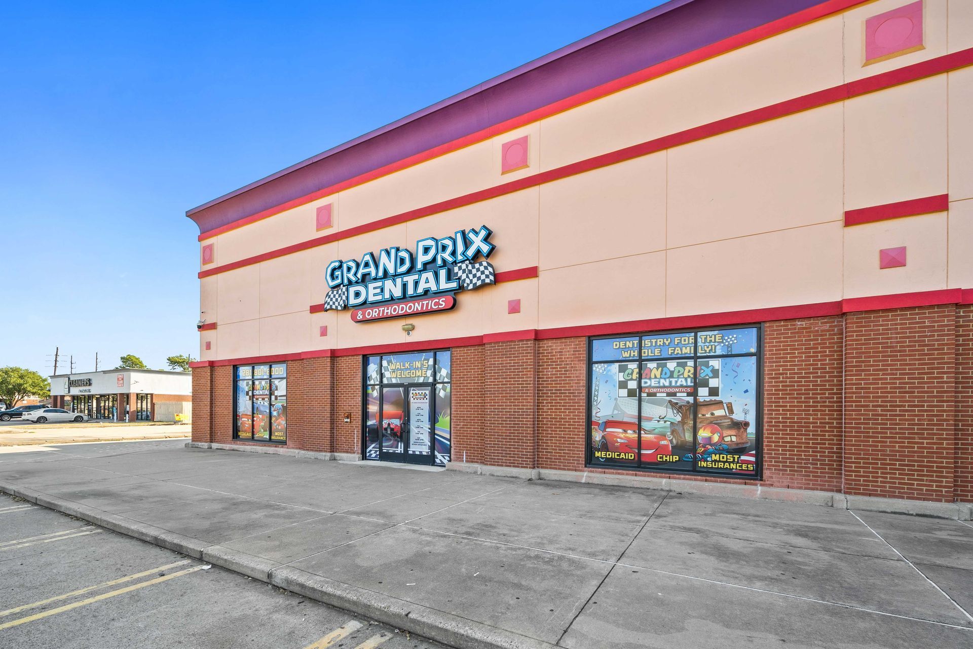 Grand Prix Dental in Katy, TX A large building with a sign that says grand prix dental