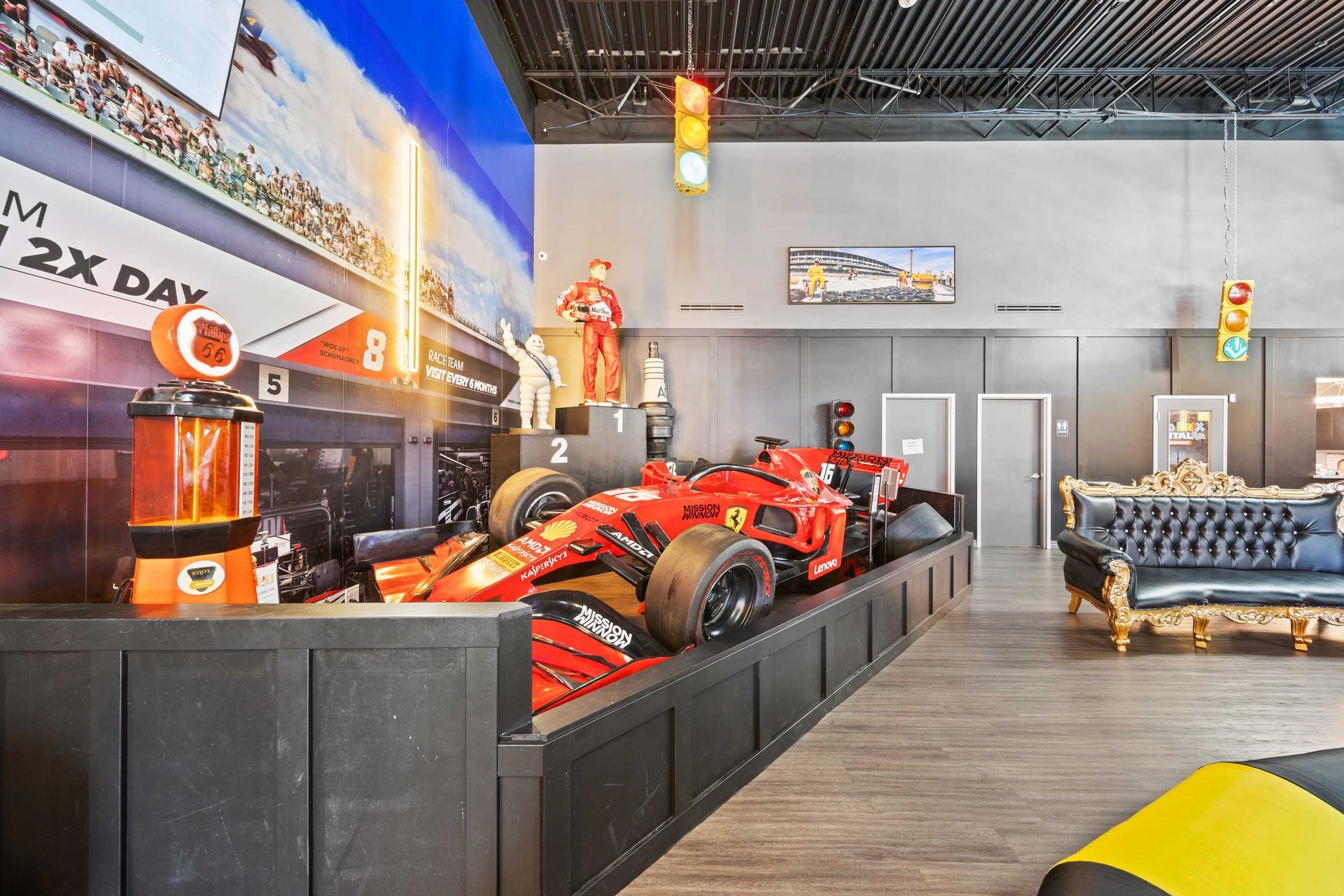 Grand Prix Dental in Katy, TX A large red race car is on display in a room.
