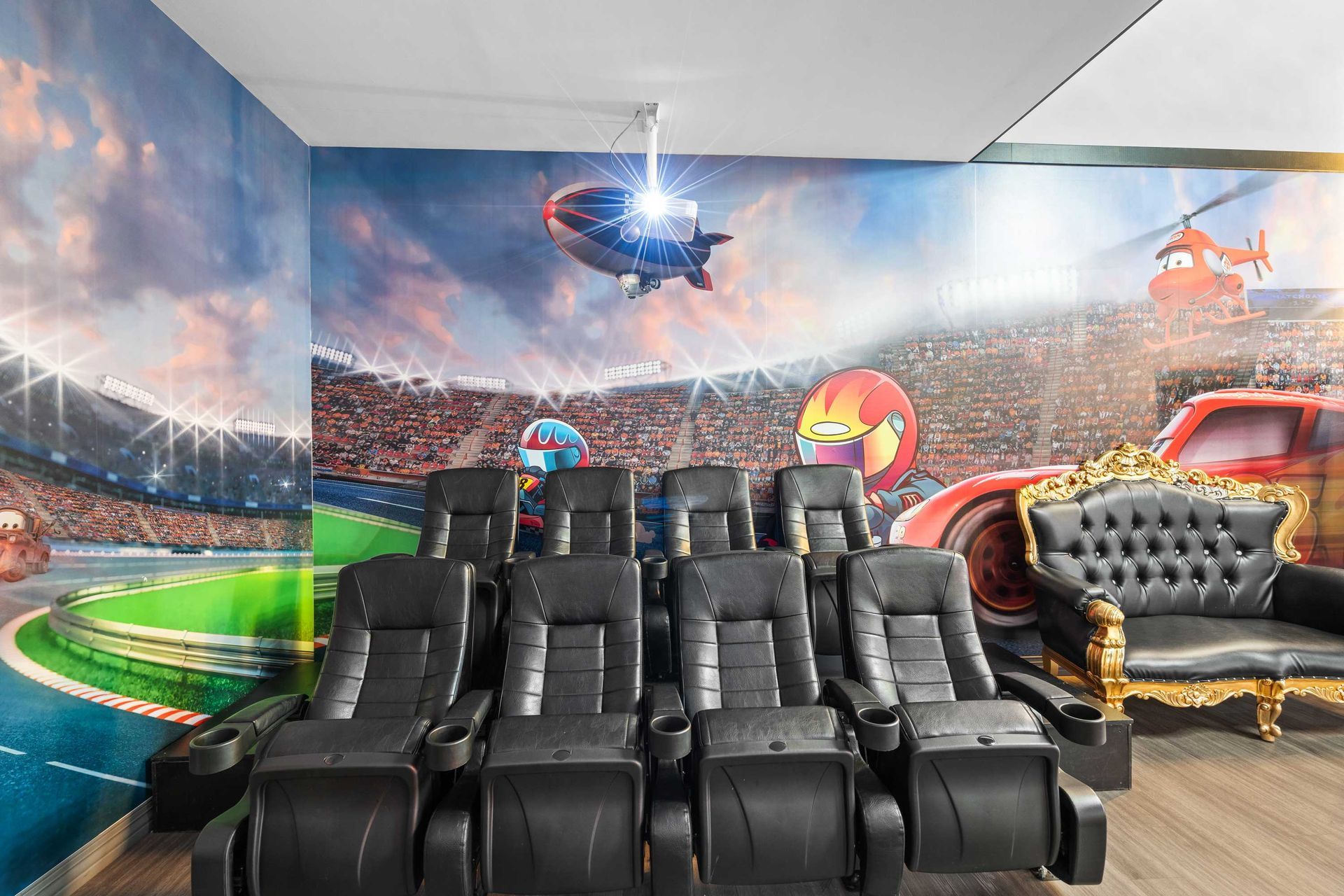 Grand Prix Dental in Katy, TX A movie theater with a couch and chairs and a mural on the wall.