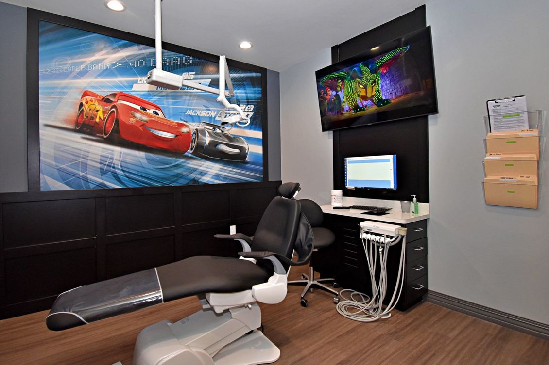 Grand Prix Dental in Katy, TX A dental office with a picture of cars on the wall