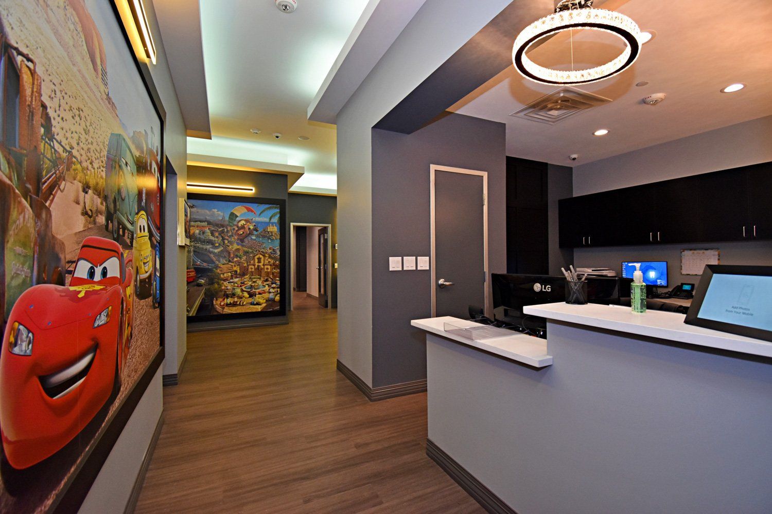 Grand Prix Dental in Katy, TX. A hallway in a dental office with a picture of lightning mcqueen on the wall.