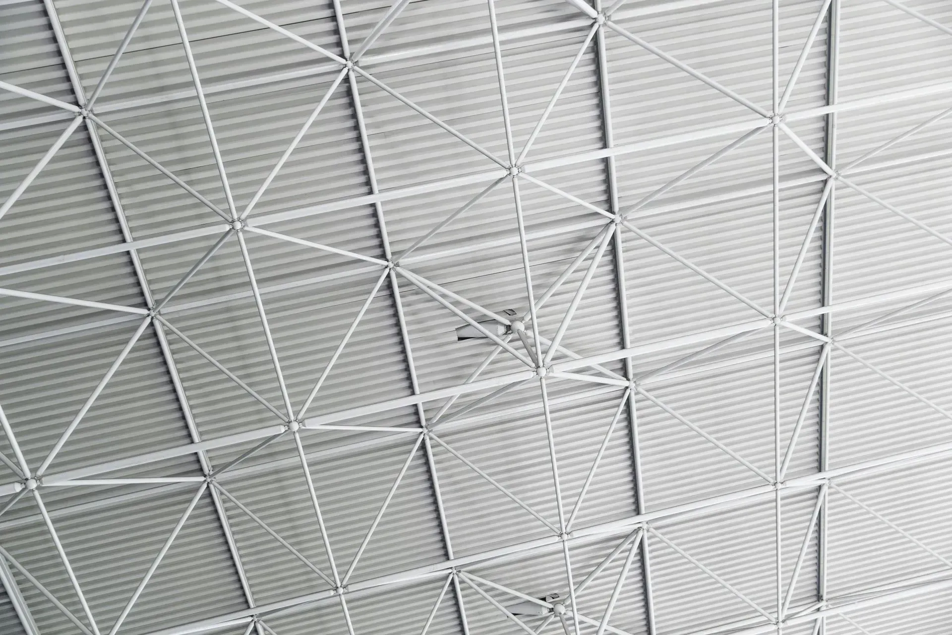 Gray metal roof with a geometric truss framework.