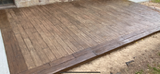 Close-up of a wooden tabletop with a natural grain finish and beveled edge