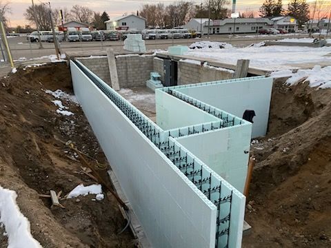 Foundation construction with insulated concrete forms in a trench at a residential building site