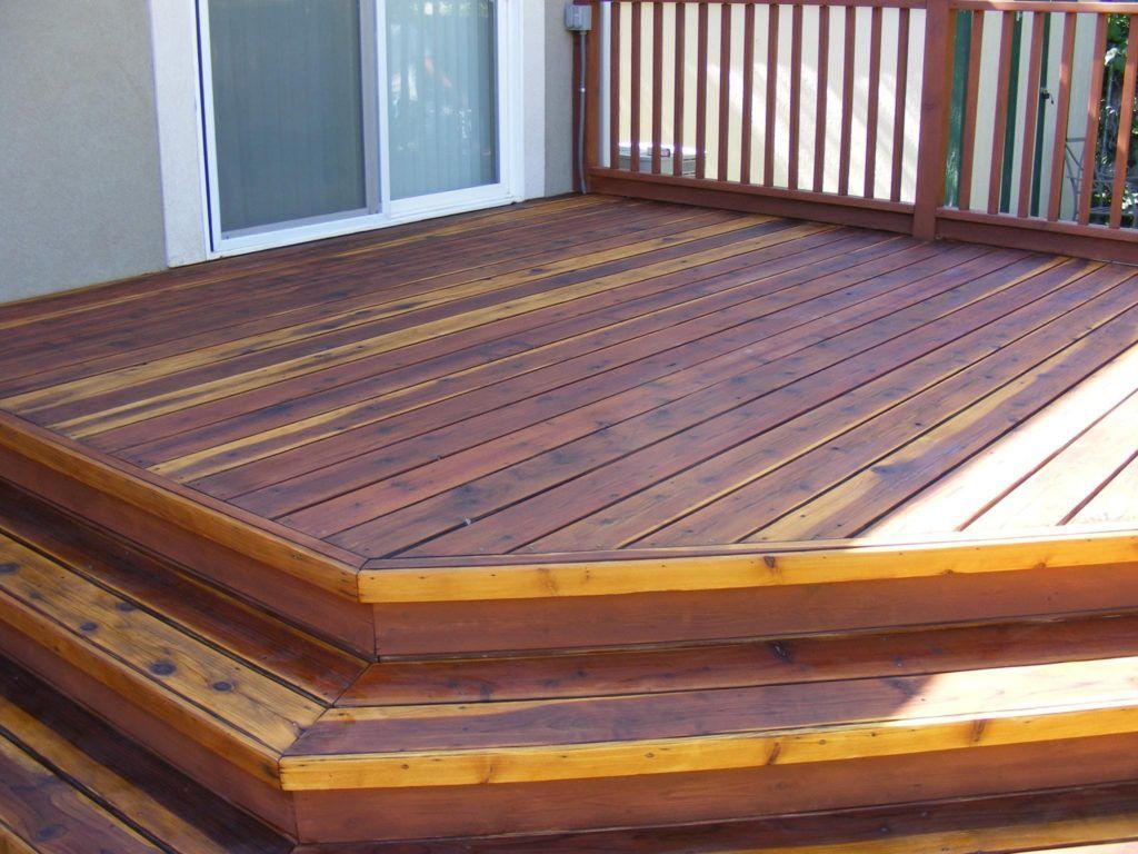 a wooden deck with stairs leading up to it