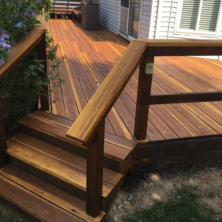 a wooden deck with stairs leading up to it