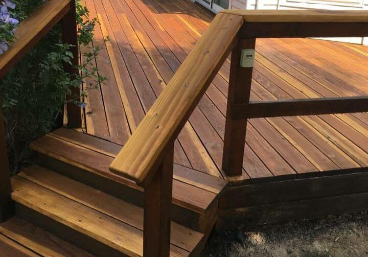 a wooden deck with stairs and a railing