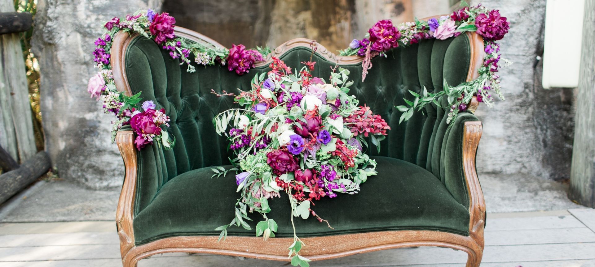 wedding sofa with floral bouquets and garlands