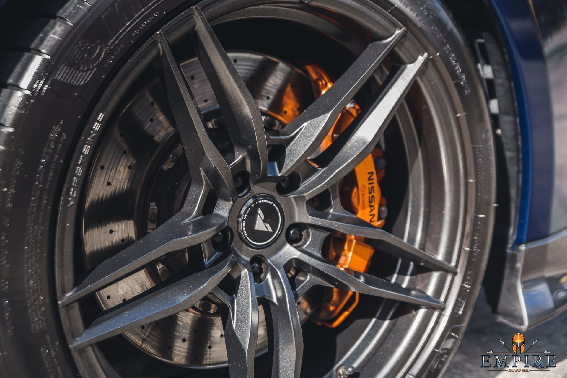A close up of a car wheel with a brake caliper on it.
