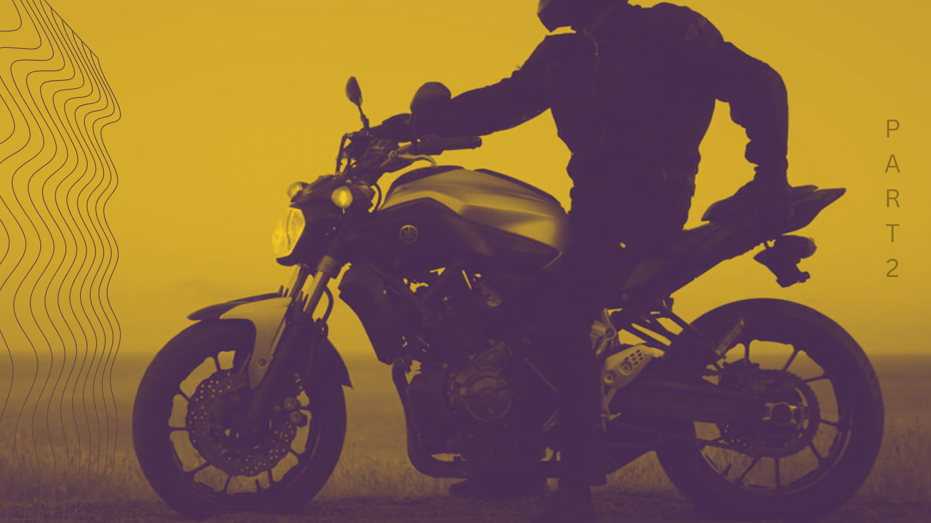 A man is riding a motorcycle in a field.