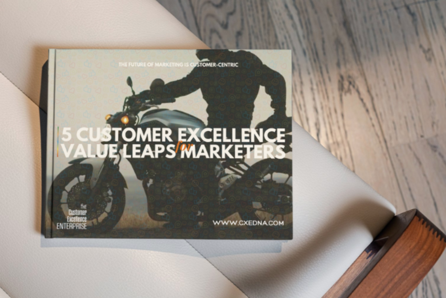 Magazine on a desk with cover headline “5 Customer Excellence Values Leaps Marketers” and a motorcycle silhouette.