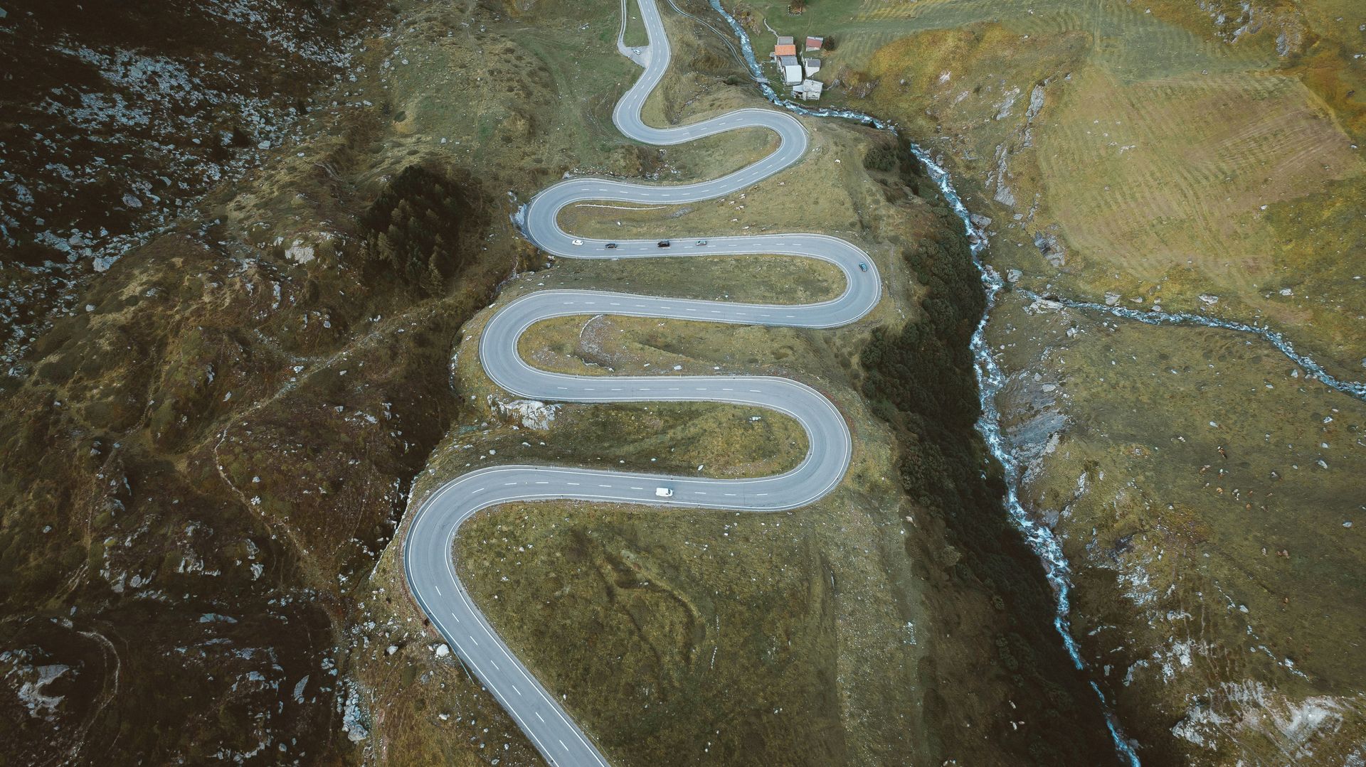 An aerial view of a winding road in the mountains.