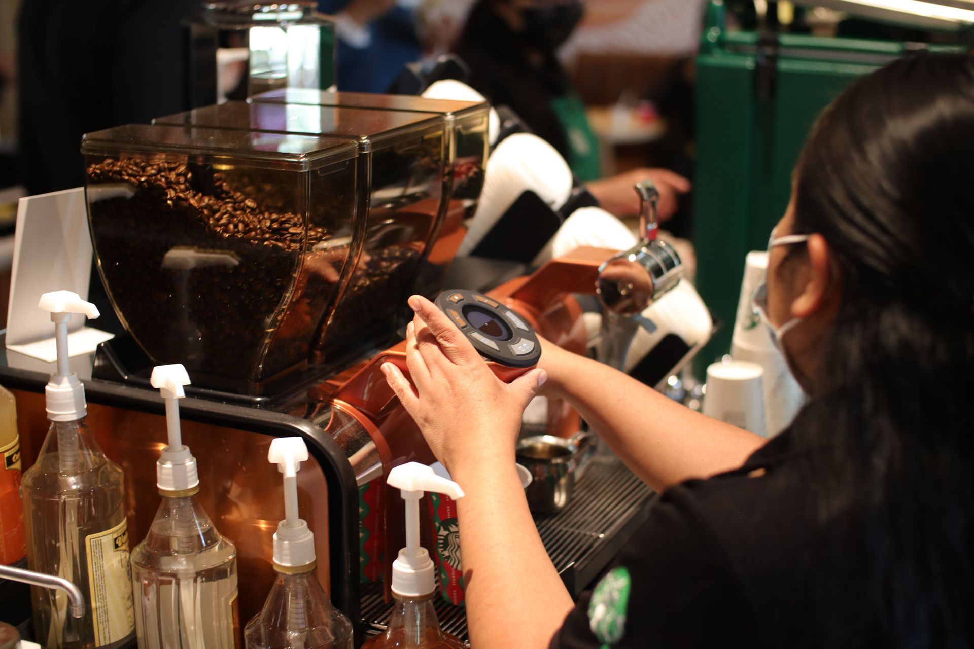 A starbucks logo is on the screen of a cell phone
