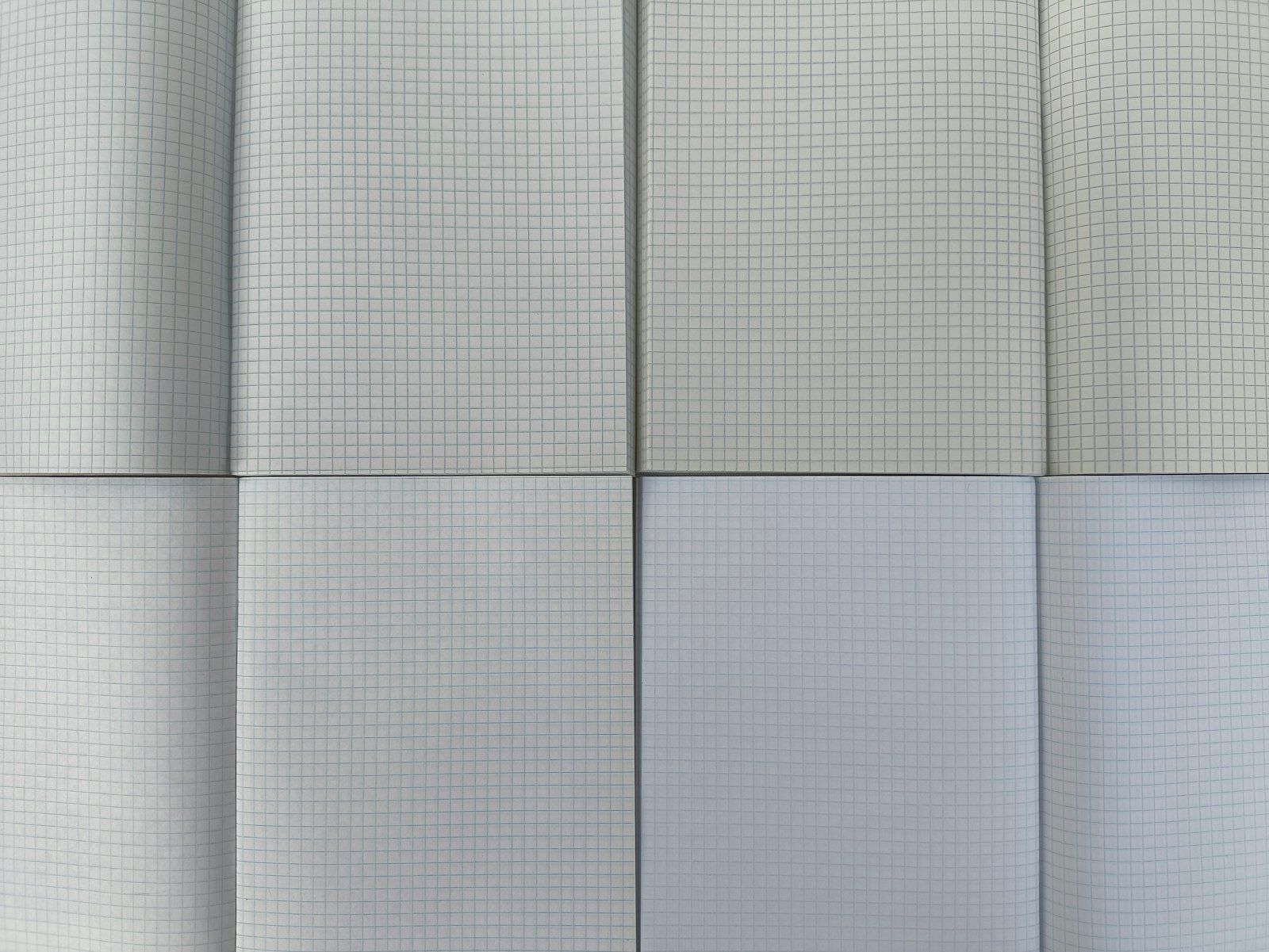 Open notebooks of blank graph paper, for a measurement grid that has never been filled in