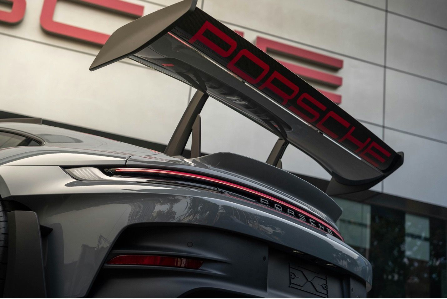 A porsche car is parked in front of a building