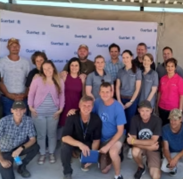 Group of people posing in front of a banner with the