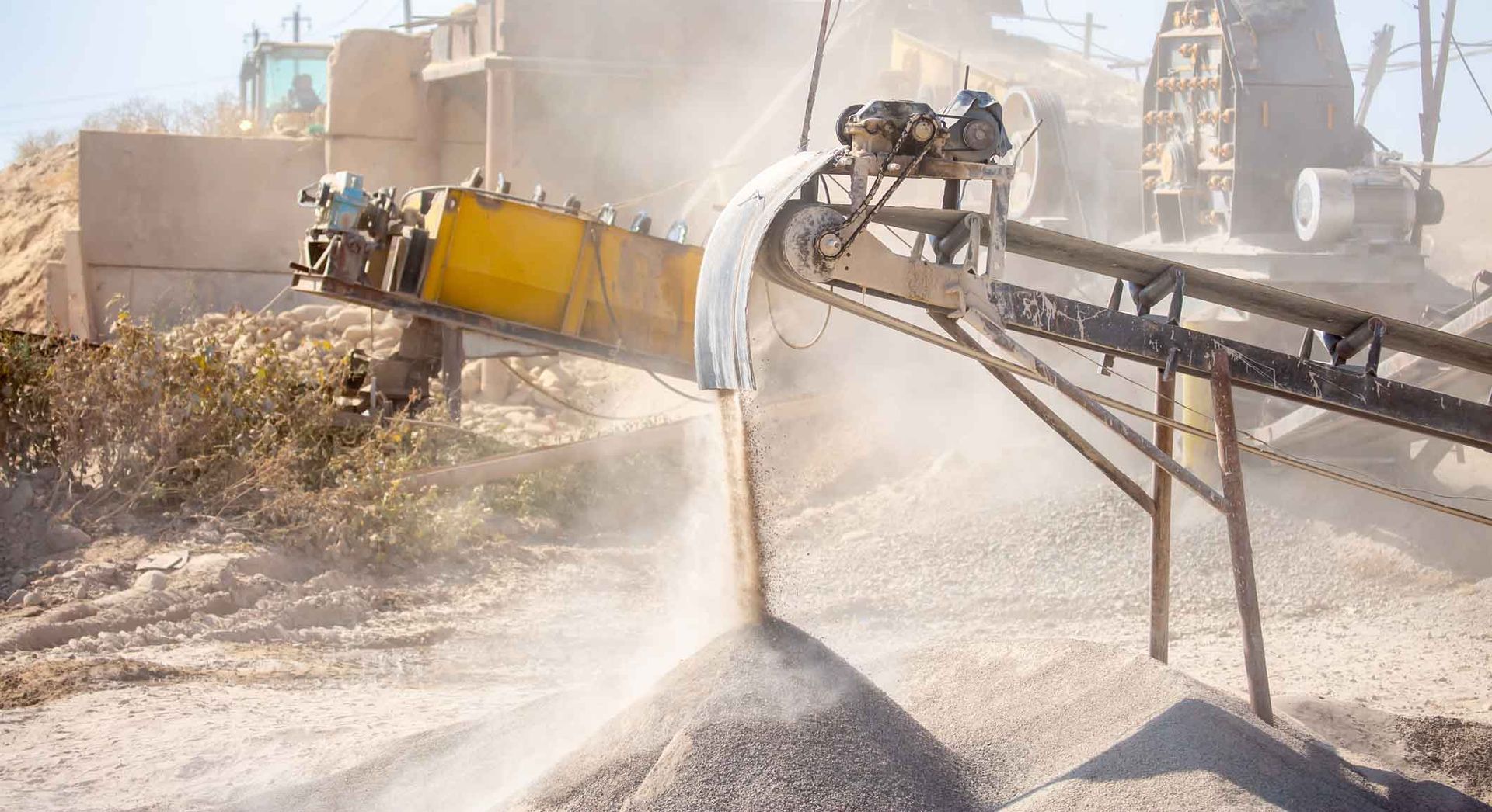 Vibrating screen stone crusher in operation.