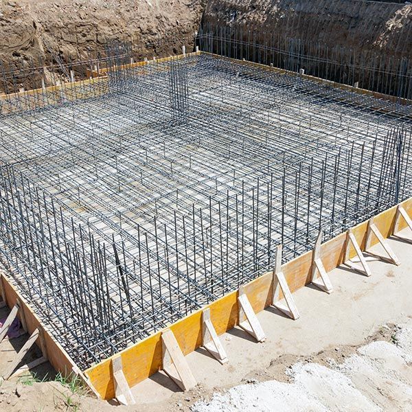 Foundation of a new house, with the beginning of a construction with layers of gravel screen.