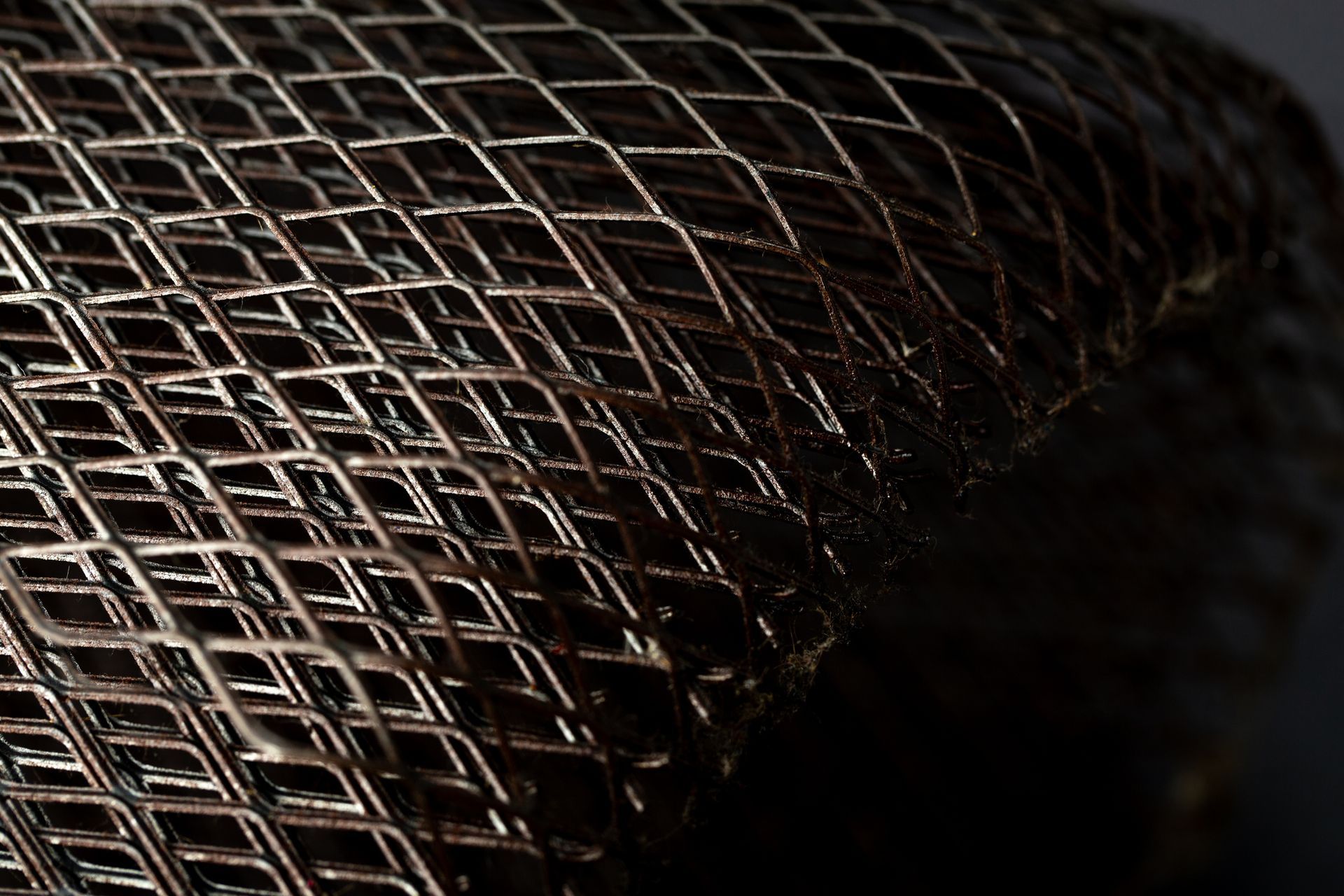Metallic lattice with interlocking diagonal mesh in geometric pattern. Metallic lattice with interlocking diagonal mesh in geometric pattern.