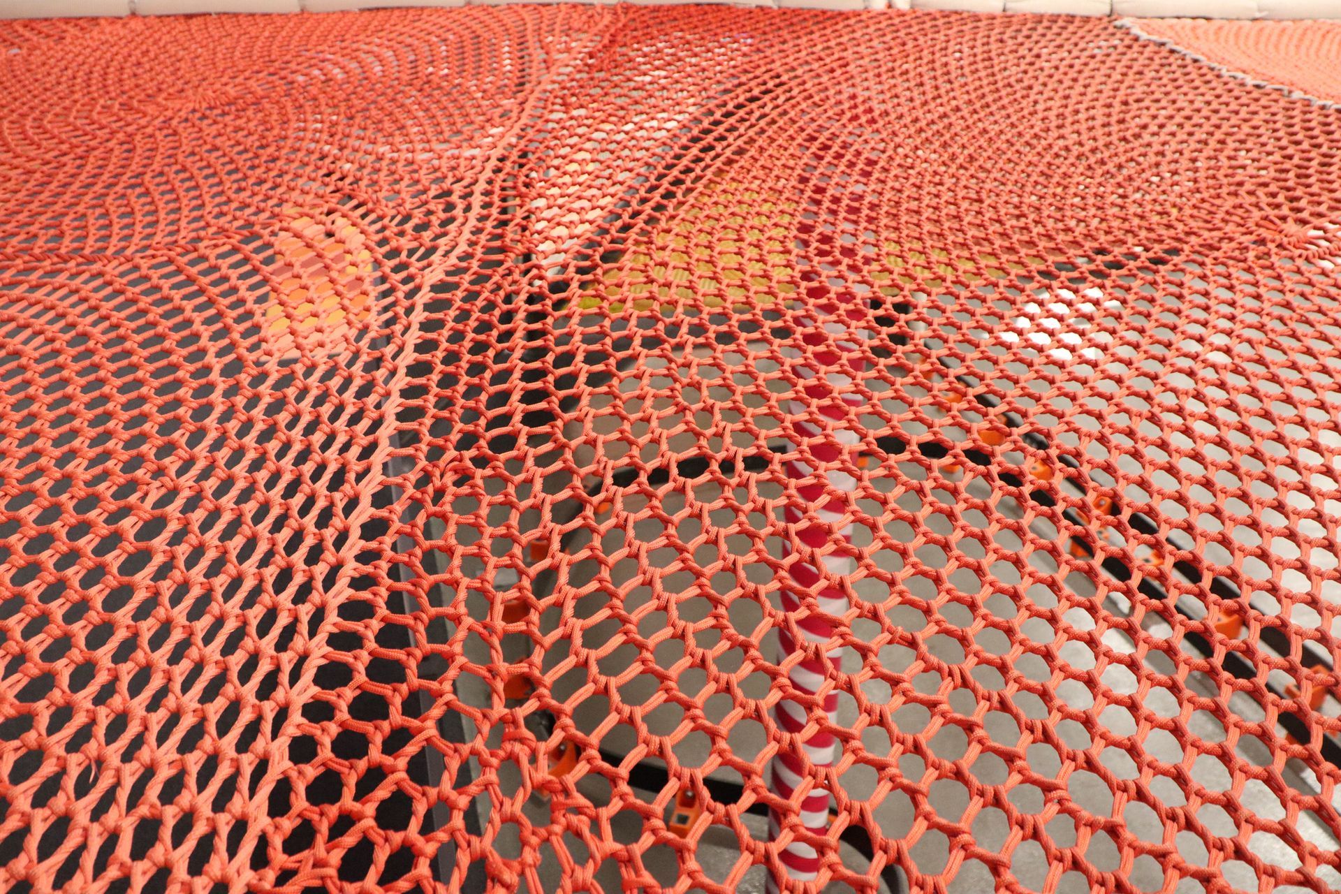 Orange safety net stretched over an indoor play area. Orange safety net stretched over an indoor play area.