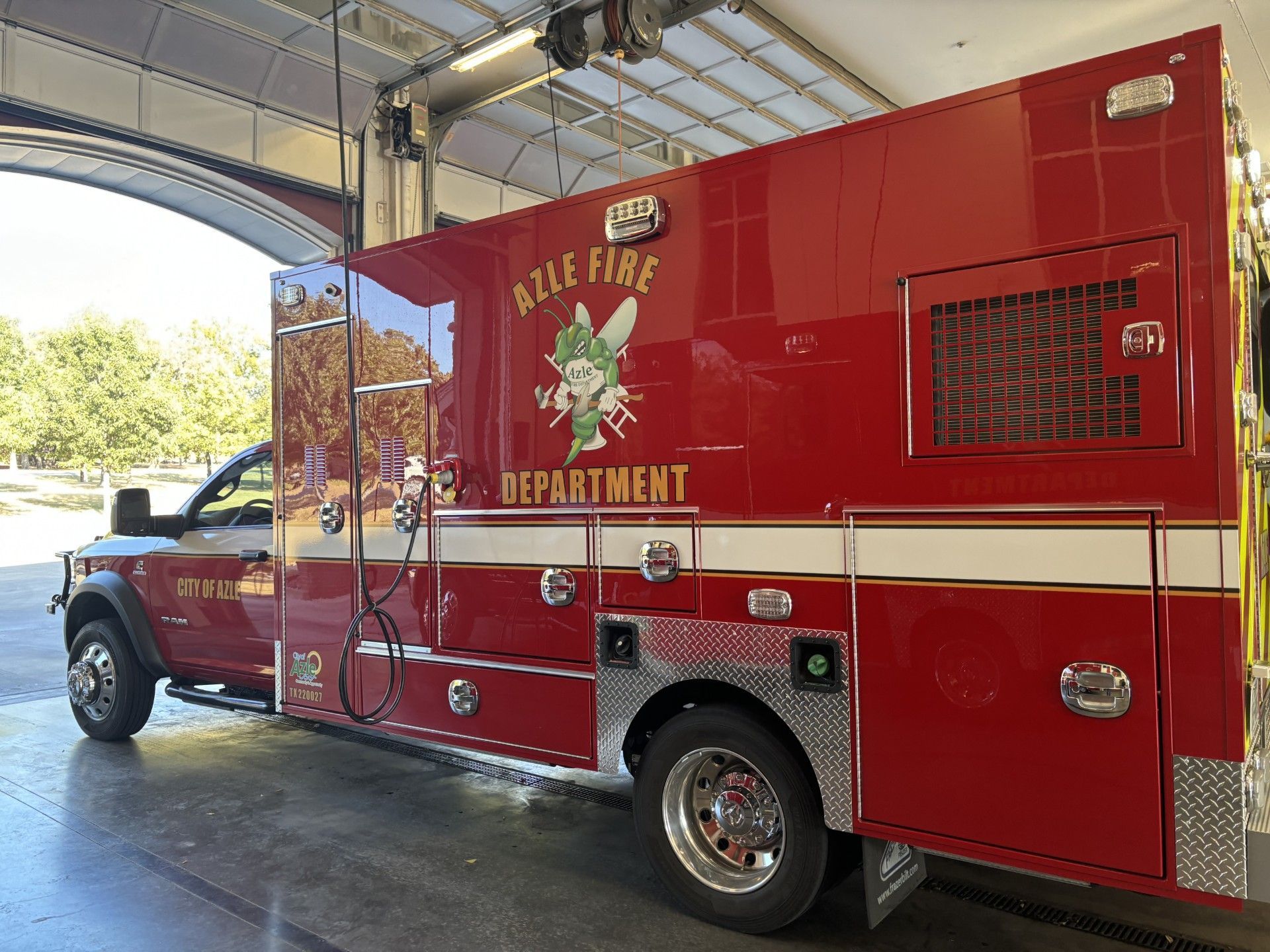 A picture of an ambulance from the Azle fire department is parked in a fire station.