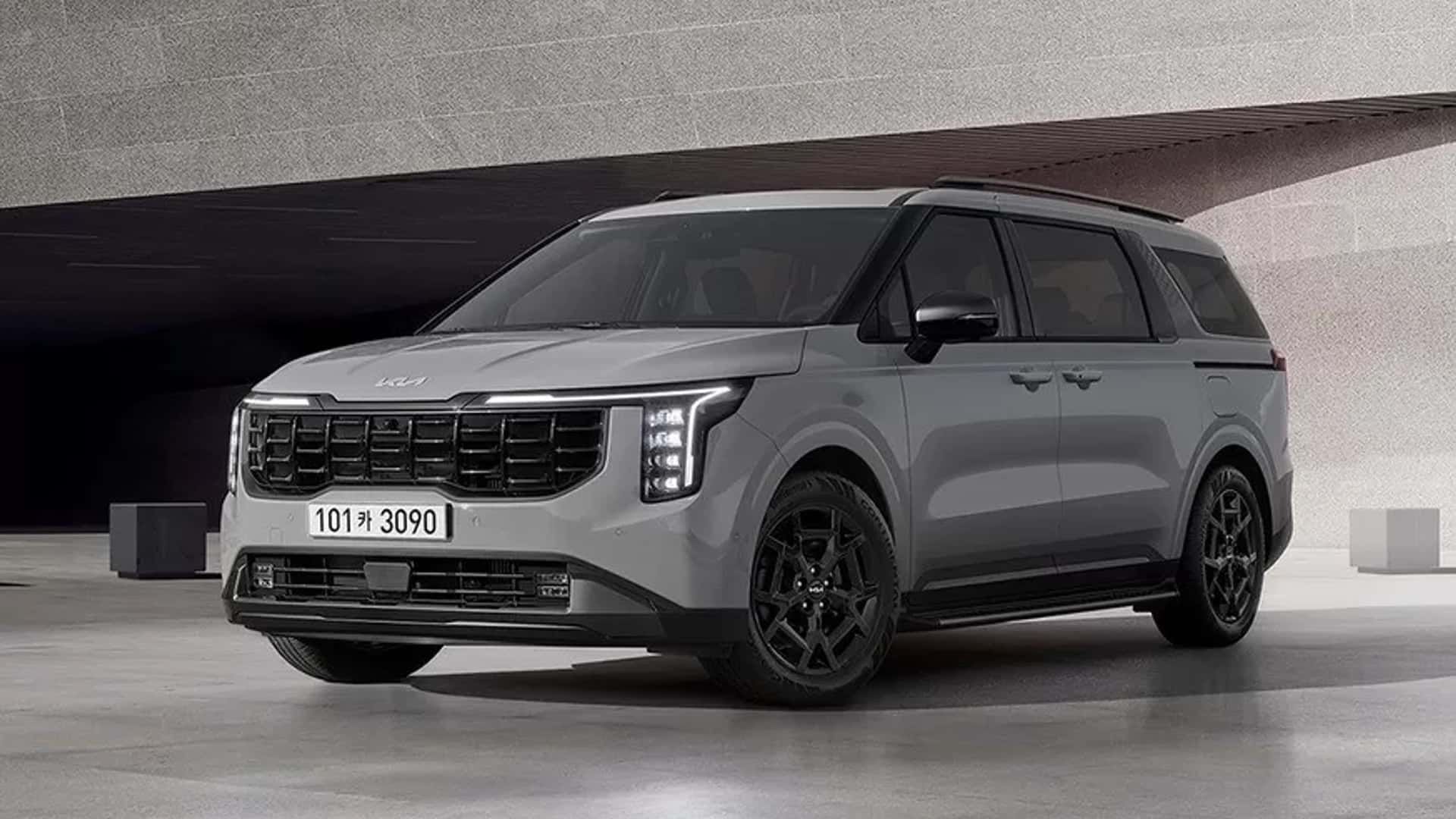 Gray Kia SUV in a studio setting, shown from the front-left with black wheels and a sleek modern design