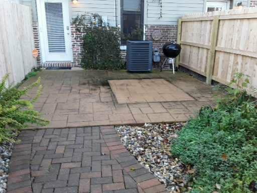Before professional paver cleaning in Belleville, IL. SprytNa Exterior restoring dirty stone patio surfaces.