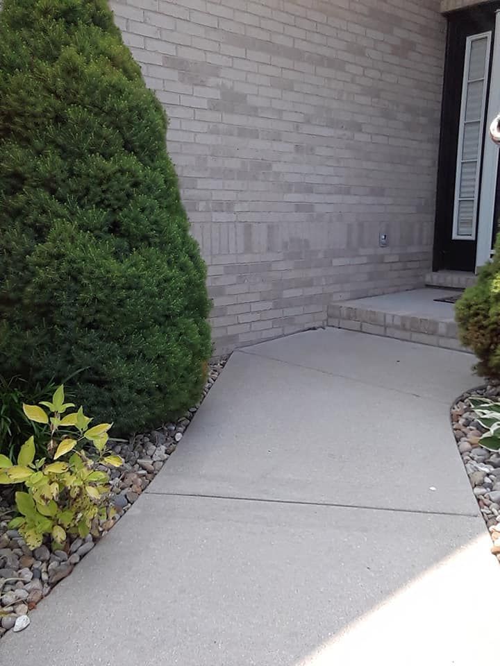 1-story house soft wash and porch entryway cleaning in Belleville, IL. SprytNa Exterior restoring bright, clean concrete.
