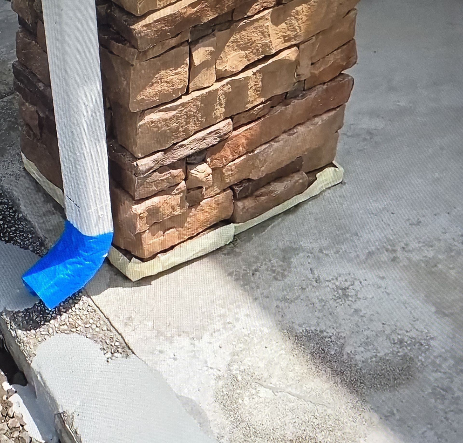 Masking tape on downspout
applying concrete overlay