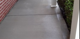 After concrete porch pressure washing in Shiloh, IL. SprytNa Exterior: Bright, clean residential entryway transformation.