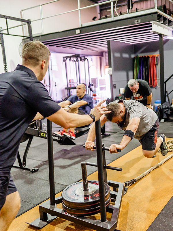 a gym trainer coaching a man