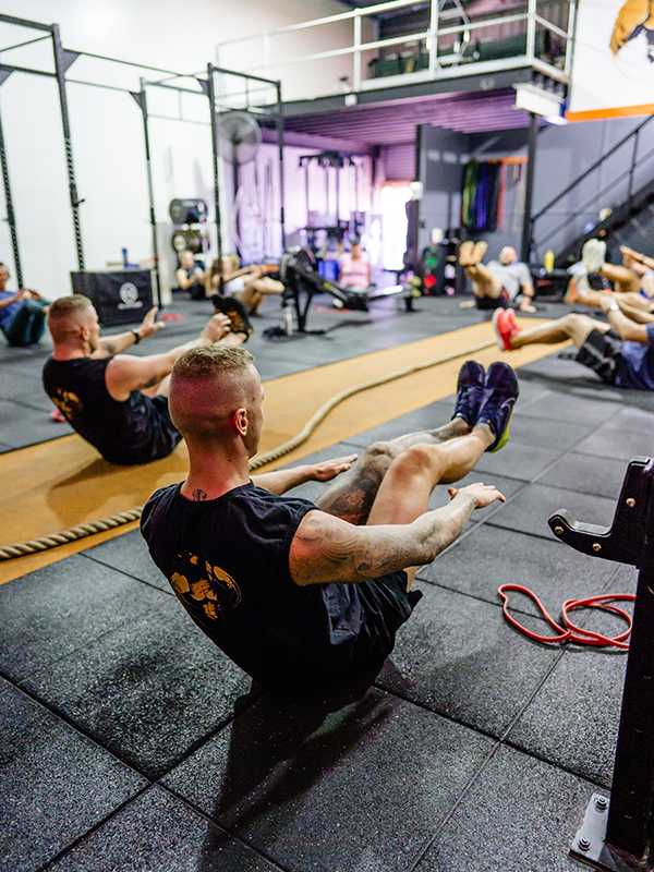 a group of men doing sitting exercises