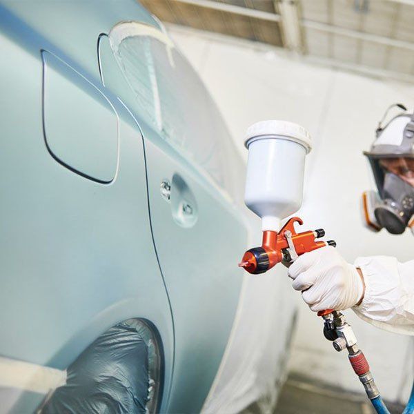 Car Painter With Painting Gun — Smash Repairs in Rockhampton QLD