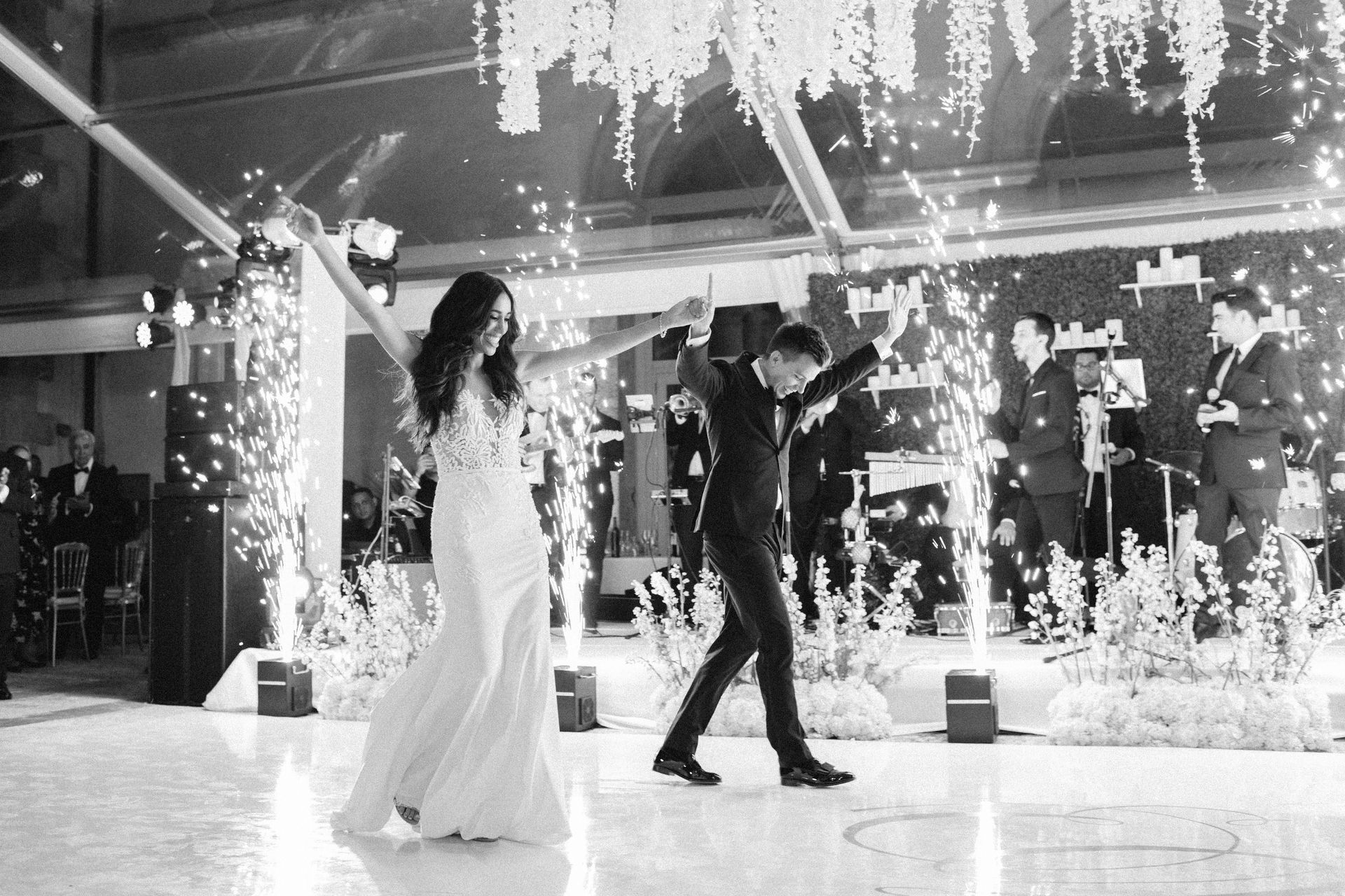 Bride and groom dancing under indoor fireworks at a wedding reception