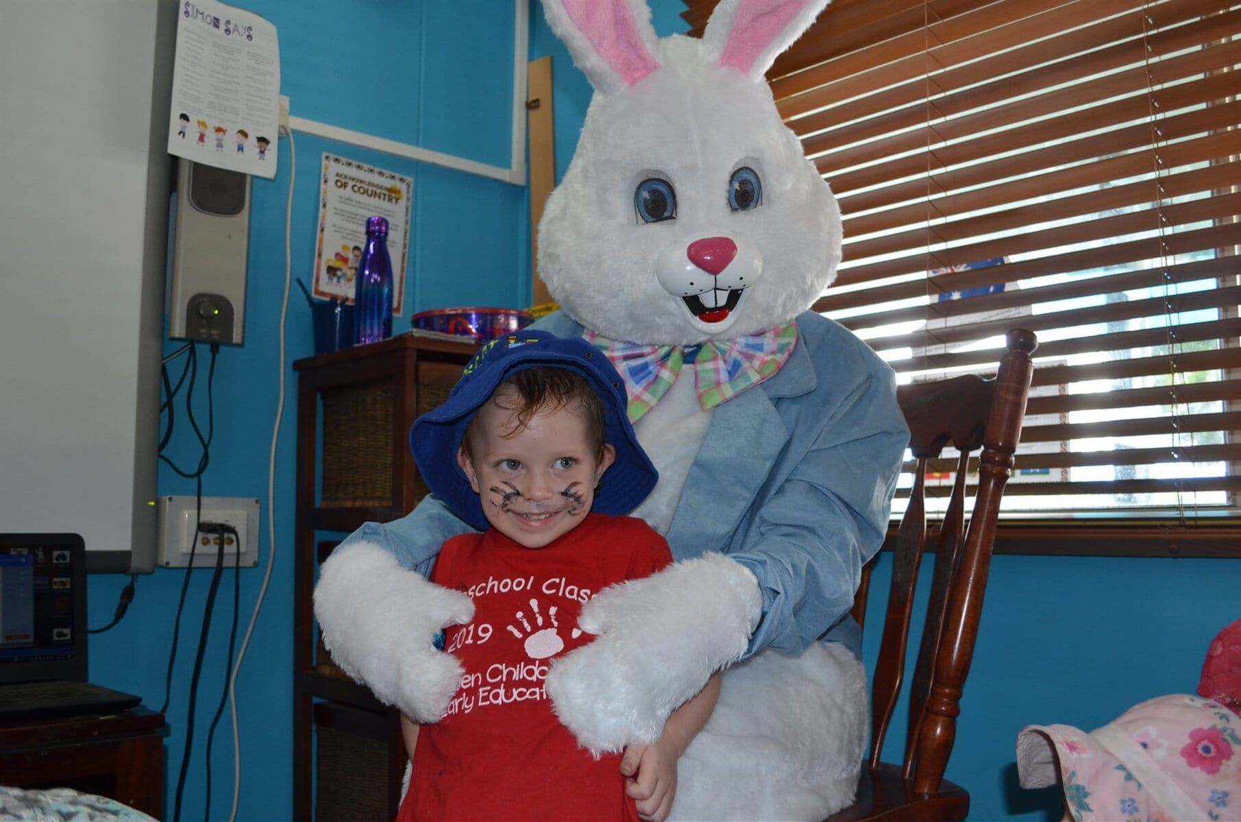 Easter Bunny Hugging Kid — Child Care in Bowen, QLD